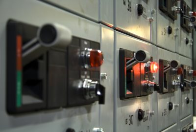 Close-up of electrical control panel with glowing red light